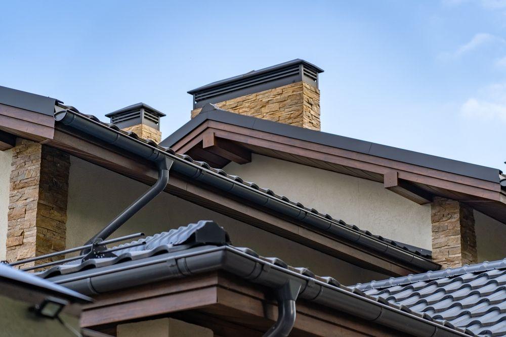 Gutters and downspouts on a home with a new roof