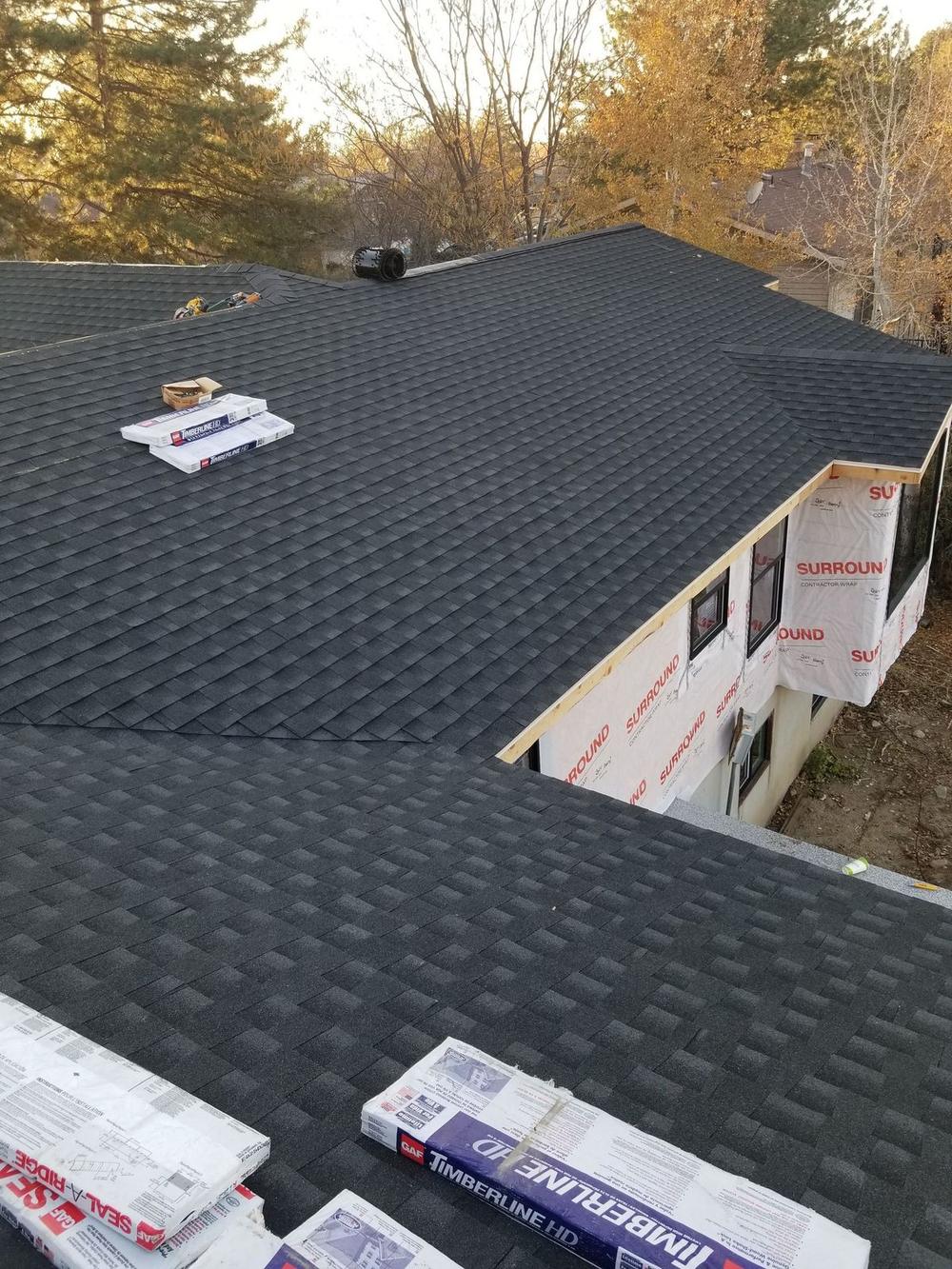 Shingle bundles staged on a roof during a Utah roof installation